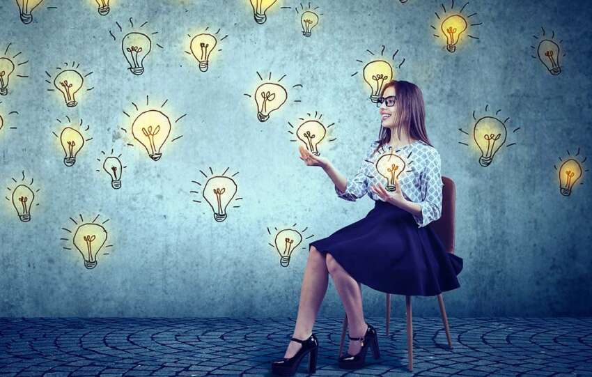 An image of someone grasping at ideas symbolized as lightbulbs