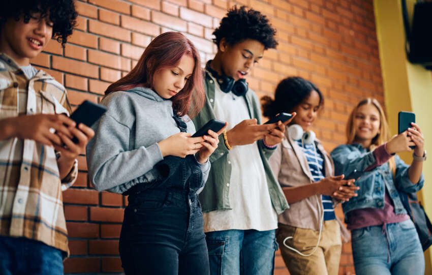 Image of a group of kids all looking at their phones