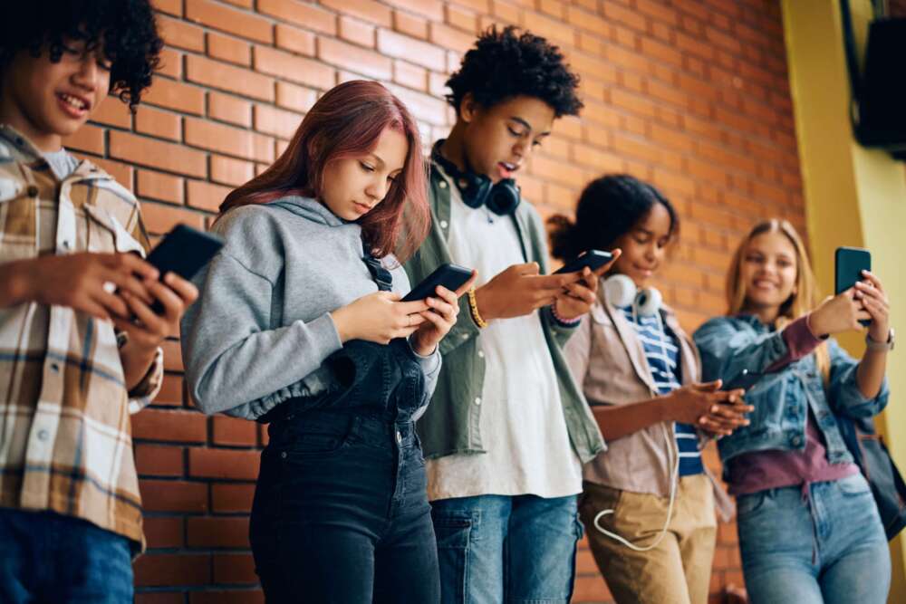 Image of a group of kids all looking at their phones