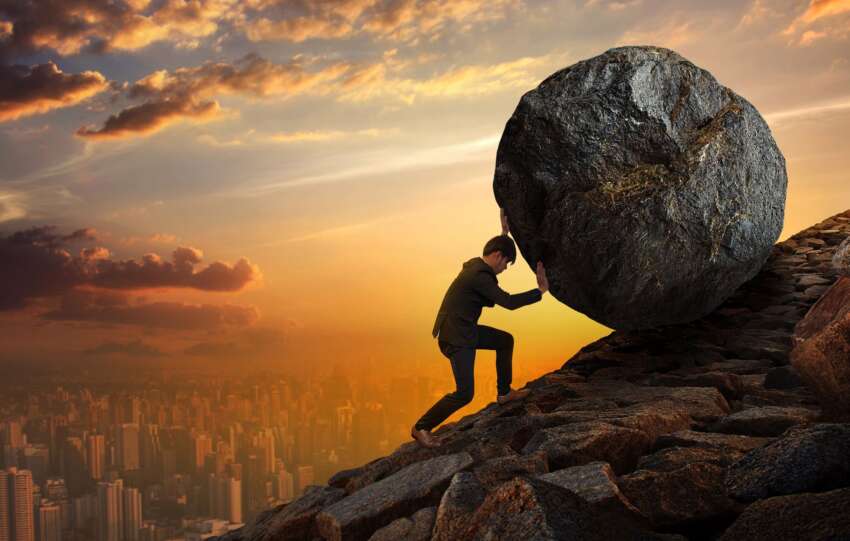 image of rock being pushed up hill to symbolize a hard life