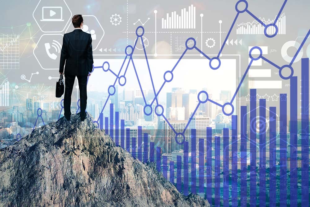 Image of a man on top of mountain symbolizing getting to the top