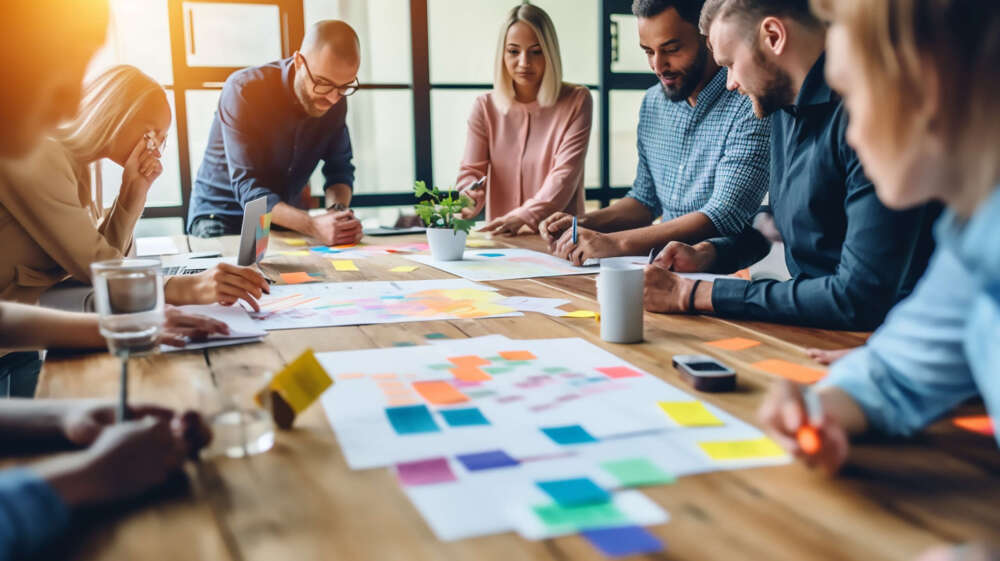 Image of team collaborating around a table